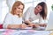 Couple of pretty businesswomen working and taking notes