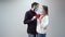 Couple in protective medical masks kissing and cover red paper heart, which they hold in their hands. celebrate valentines d