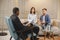 Couple at pshycologist appointment sitting in modern office