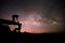 Couple pull each other on Stone lodge under night sky stars