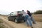 Couple pushing a car