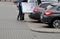 COUPLE PUSHING LARGE FINLUX TELEVISION IN VEHICLE TRUNCK