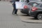 COUPLE PUSHING LARGE FINLUX TELEVISION IN VEHICLE TRUNCK