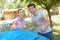 Couple putting up tent making positive thums up gesture