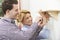 Couple Putting Up Wooden Shelf Together At Home