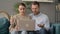 Couple Reacting to Loss on Laptop while Sitting on Sofa