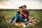 Couple reads book together, picnic in the field