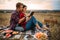 Couple reads book together, picnic on the grass