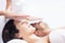 Couple receiving a head massage from masseur