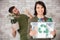 couple recycling empty plastic bottles