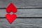 Couple of red paper hearts on gray wood, simple love story, break up