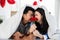 Couple with red rose flower, lovely couple lying in a bed, happy smile kissing, concept of valentine day