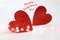 Couple of red wooden hearts. Glitter overlay