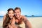 Couple relaxing on beach taking selfie picture