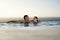 Couple Relaxing In Infinity Pool At Resort