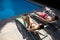 Couple relaxing on lounge chair at poolside