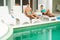 Couple relaxing near swimming pool