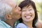 Couple relaxing outdoors in park kissing