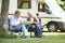 Couple Relaxing Outside Motor Home On Vacation