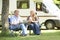 Couple Relaxing Outside Motor Home On Vacation