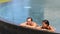 Couple relaxing together in swimming pool on vacation