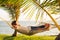 Couple relaxing in tropical hammock