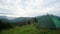 The couple rested in a green tent and looked at the beautiful mountains.