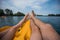 A couple of resting on a pedal boat on the lake. legs of men and women standing on the pedals of the boat