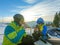 couple resting on the top of the hill drinking warm up tea. snowboarding skiing