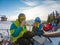 couple resting on the top of the hill drinking warm up tea. snowboarding skiing