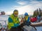 couple resting on the top of the hill drinking warm up tea. snowboarding skiing