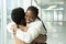 Couple reunion in airport: african female met hug boyfriend arriving after vacation or trip abroad
