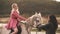 Couple ride on horse. Contryside vacation. Girl on ranch with horses. Outdoor leisure.