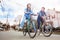 Couple ride laughing bikes together on street