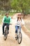 Couple riding bicycle in park