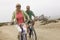 Couple Riding Bicycles On Beach