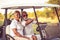 Couple are riding in a golf cart and talking