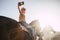 Couple riding horses take a selfie with modern technology smartphone. cowboy lifestyle and smile woman. sunset time and backlight