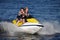 Couple riding jet ski