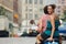 Couple Riding On Moped In Street