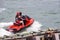 Couple Riding Tandem on a Red Jetski