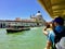 A couple riding a water taxi taking a photo from the Grand Canal of Santa Maria della Salute, the famous venetian church,