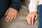 Couple with rings sitting on sofa, closeup. Concept of divorce