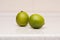 Couple of ripe green limes on the table