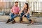 Couple on rollerblades sitting.