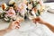 Couple on romantic date. Friends clinking glasses, top view. White wine, flowers around on marble table. Wedding celebration,