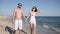 Couple romantic walk on beach, lovers people walking around arm barefoot on sand, Summer, couple in love, an exotic