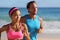 Couple runners running on beach. Interracial young adults asian woman, caucasian man, training cardio together doing