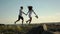 Couple running along the rocks on promenade