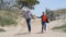 Couple running down to the beach